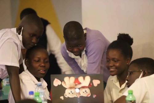 Young Partticipants Sharing a computer to watch a Clip about some of the Successful Women in the ICT sector